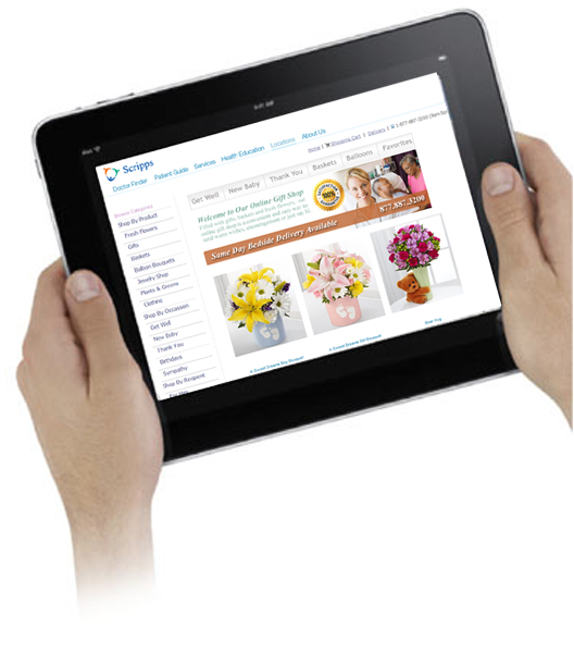 2 hands holding an iPad displaying the Scripps HospitalGiftShop website